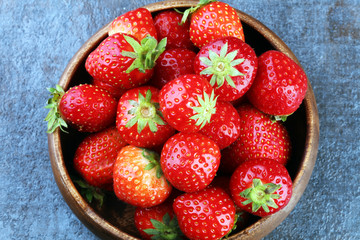 Fresh red strawberry loosely laid in different positions.