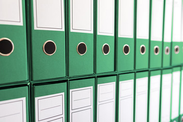 Binder folders in shelf, binders in a row.