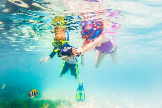 Boy and Girl Snorkeling On Tropical Reef In Cuba Caribbean Island With Underwater Camera