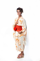Teen age girl dressed in casual Japanese Yukata kimono standing with hands close.