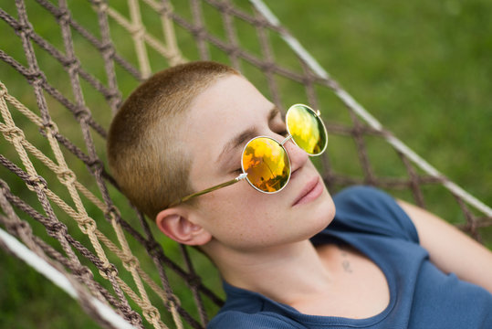 Portrait of woman with retro sunglasses lay on sunbed