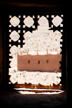Views from a broken window os a fortified mudbrick kasbah in the Draa Valley, Morocco