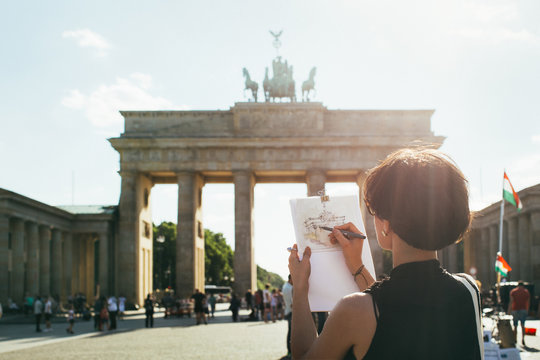 Young Female Artist Drawing Berlin's Brandenburg Gate on Sunny Day
