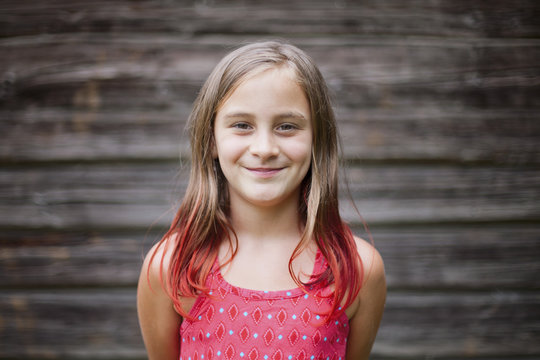 Headshot of nine year old girl with brown and red hair
