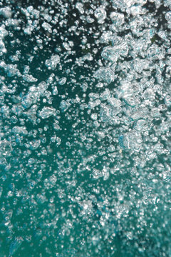 Abstract of air bubbles exhaled by a scuba diver expending on their way towards the surface