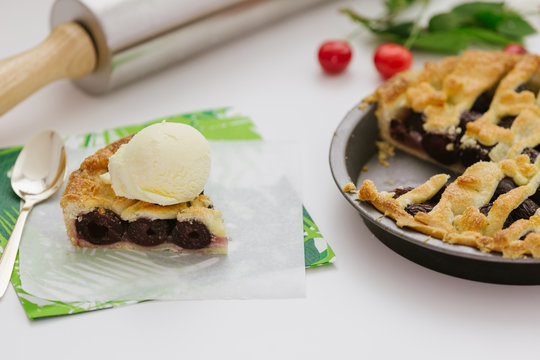 Slice of cherry pie with vanilla ice cream