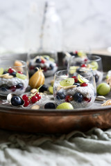 Chia seed,fruit puddings in glasses on a serving tray.