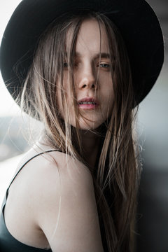 sensual portrait of a beautiful girl in the hat close-up