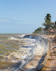 The tide bursts with the rock barrier. High tide.
