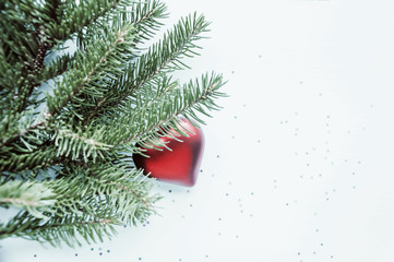 Composition of Christmas decorations on a spruce branch and toning.