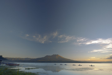 KINTAMANI, BALI, INDONESIA–JUNE 4 : Fishing boats dock in the lake at dawn on June 4, 2006 in Kintamani lake, Bali, Indonesia. Kintamani lake is the largest lake in Bali.