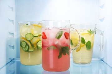 Jugs of fresh lemonade in fridge