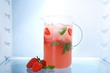 Jug of fresh strawberry lemonade in fridge