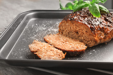 Tasty turkey meatloaf on baking tray, closeup