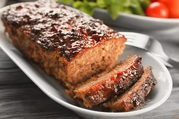 Fototapeten Plate with tasty baked turkey meatloaf on table, closeup © Africa Studio