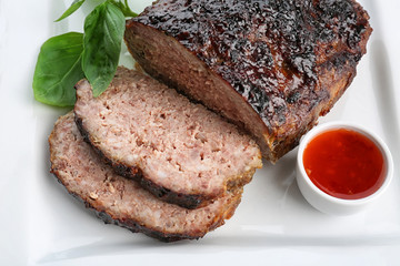 Tasty baked turkey meatloaf on plate, closeup