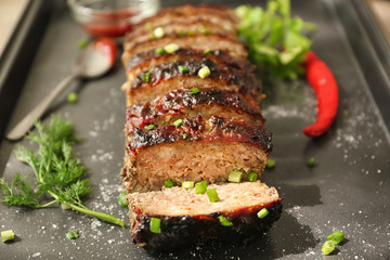 Tasty sliced turkey meatloaf on baking tray