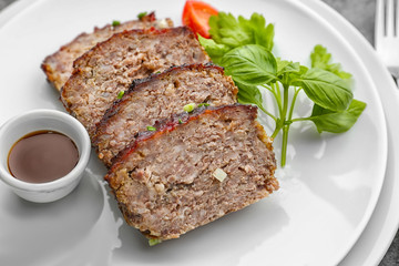 Sliced tasty turkey meatloaf on plates, closeup