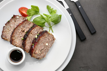 Sliced tasty turkey meatloaf served for dinner on table