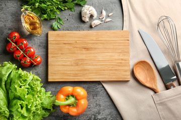 Wooden board and vegetables on kitchen table. Cooking classes concept