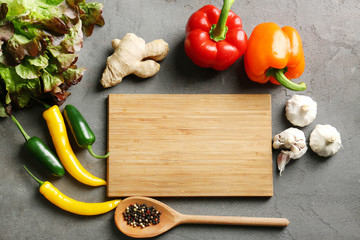 Wooden board and vegetables on kitchen table. Cooking classes concept