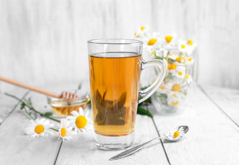 Cup of chamomile tea on wooden background