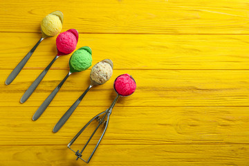 Composition with colorful scoops of ice-cream on wooden background