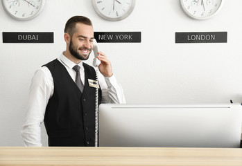 Male hotel receptionist at workplace