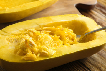 Fresh spaghetti squash with spoon on table, close up
