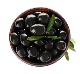Bowl with ripe olives on white background