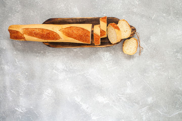 Sliced bread over gray stone table. Top view from above with copy space.