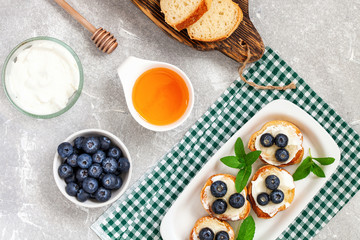  breakfast set with ricotta, blueberries and honey sandwiches