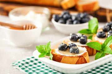  breakfast set with ricotta, blueberries and honey sandwiches