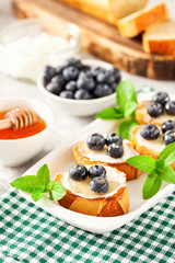  breakfast set with ricotta, blueberries and honey sandwiches