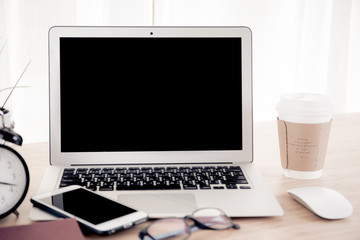 Laptop with smart phone notebook and coffee cup