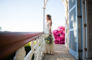 Pretty bride holding bouquet while standing in balcony © WavebreakMediaMicro