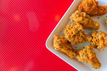 Outdoor kussens kentucky style fried chicken on red background with space for text © Quality Stock Arts