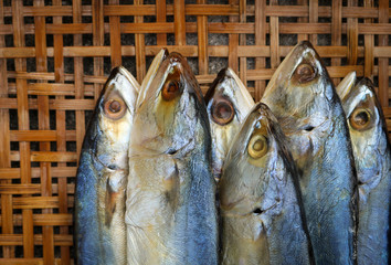 Salted mackerel on bamboo wicker background.