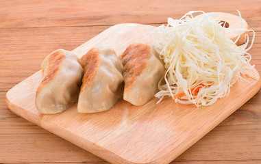 Japanese style dumplings on wooden floor