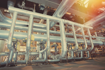 equipment, cables and piping as found inside of a modern industrial power plant