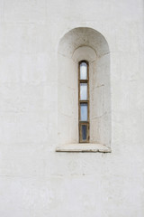 Vintage wooden window. Loophole of castle. White grunge wall