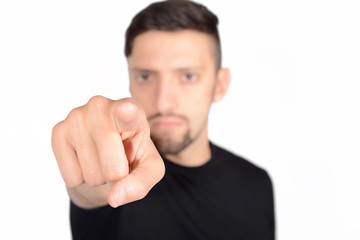Portrait of young latin man pointing to camera.
