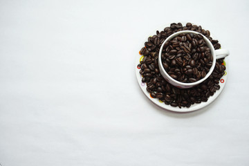 Fototapeta na wymiar Coffee bean in a cup on a white isolated background.