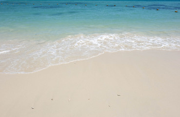 Fototapeta na wymiar white sand and blue sea in sunshine day