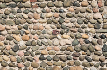 Pebblestone wall in brown, red and white shades