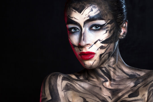 Разрисованная женщина в черно белой гамме с красными губами.