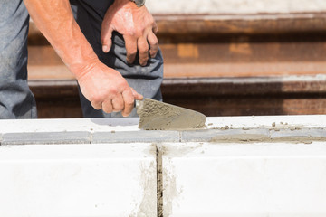 Construction worker working hard and leveling concrete pavement outdoors.