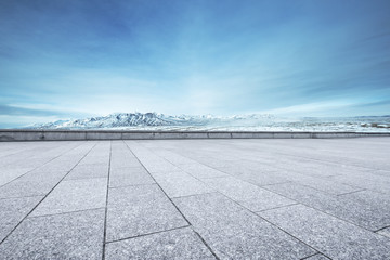 empty floor with beautiful snow mountains in blue sky