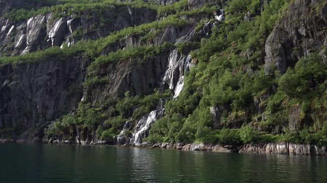 Waterfall on rock in the Norwegian Sea in Troll fjord