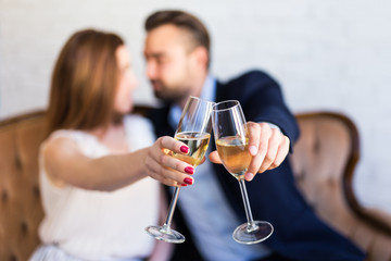 relationship and anniversary concept - couple with champagne glasses